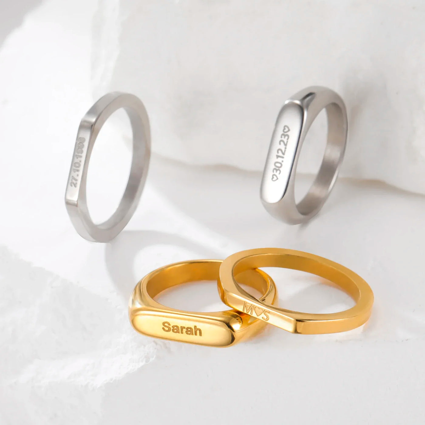 Personalised couple rings in gold and silver, engraved with a name and a date