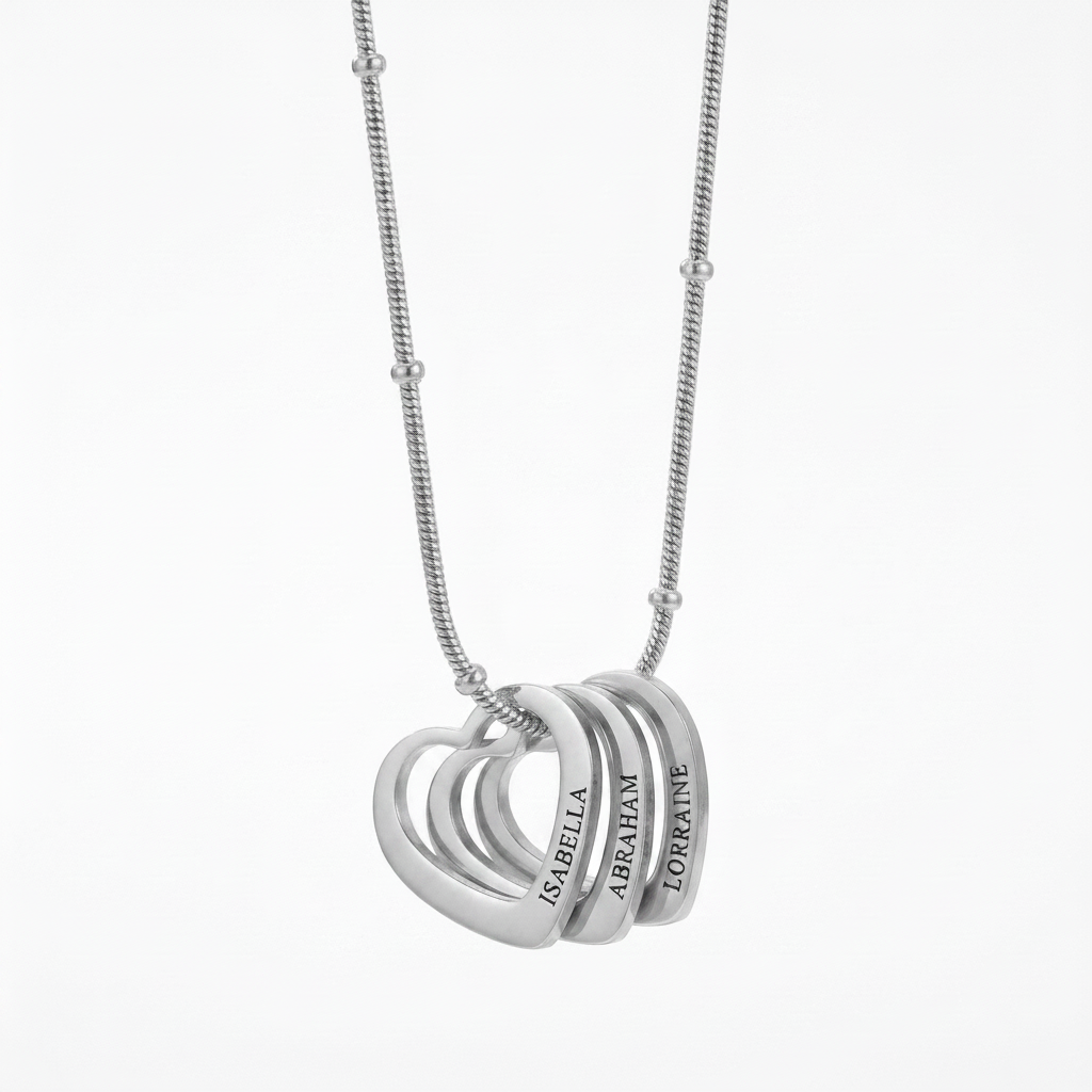 Close-up of three interlocking engraved hearts on a bead chain